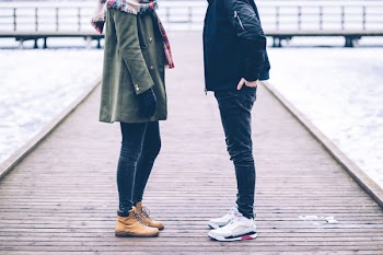 Two people standing on the pier