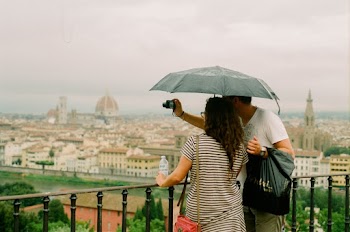 Two People Taking Photo of City