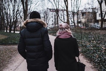Two people walking in the park