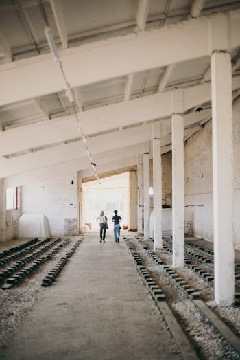 Two People Walking Near Pillars