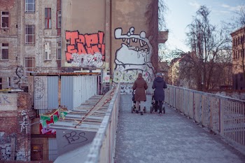 Two People Walking on Bridge