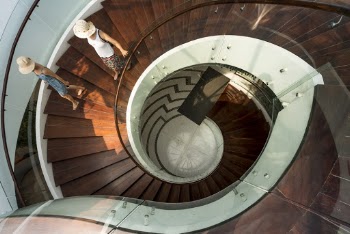 Two People Walking On Spiral Stairs