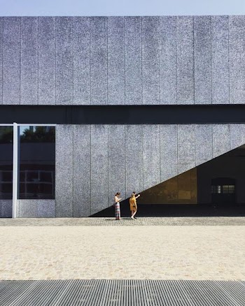 two person beside gray wall