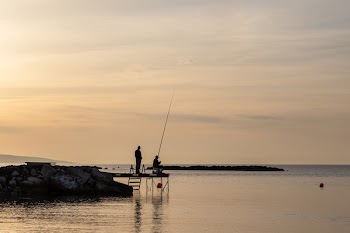 Two Person Having Fishing on Dock