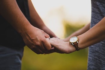 two person holding each other's hands