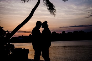 Two Person Hugging Near Tree during Sunset