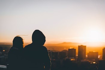 two person looking on buildings