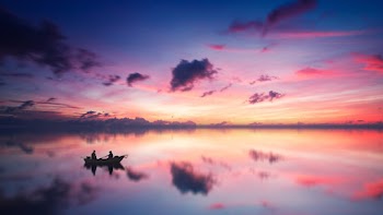 Two Person on Boat in Body of Water during Golden Hour