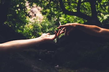 two person reaching each others hand