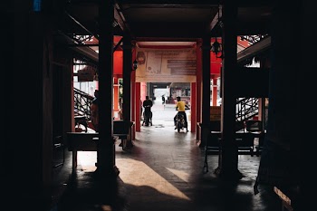 Two Person Riding on Motorcycle Surrounded by Buildings