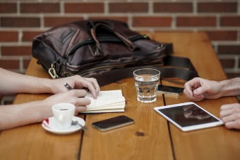 two person sitting in front of table