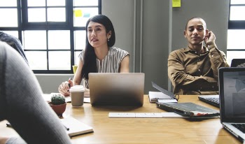 Two Person Sitting In Front Of Table