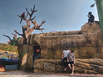 Two Person Standing in a Waterfalls