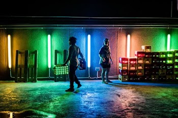 two person standing near green and blue neon lights