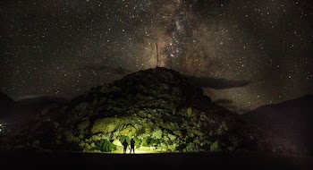 two person standing near mountain