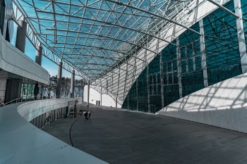Two Person Standing Near White Concrete Building