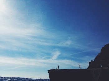 Two Person Standing on Cliff