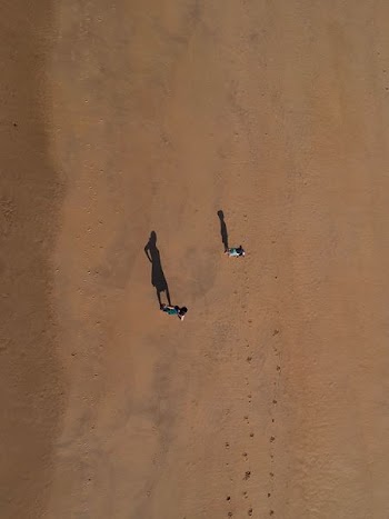 two person standing on desert at daytime