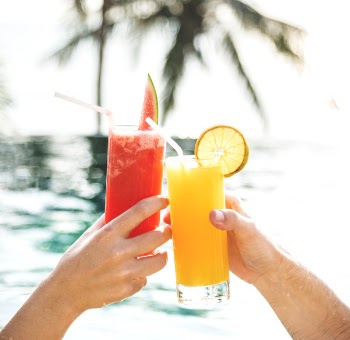 Two Person Toasting Glasses With Juice