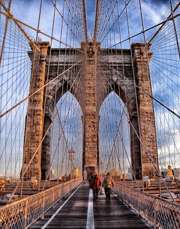 Two Person Walking on Bridge during Daytime