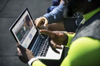 Two Person Watching Video On Laptop