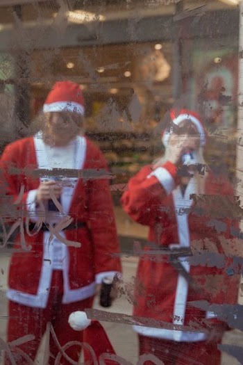 two person wearing Santa costumes