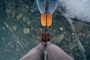 Two Person Wearing Shoes in Front of Each Other