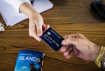 Two Persons Holding Premium Credit Card