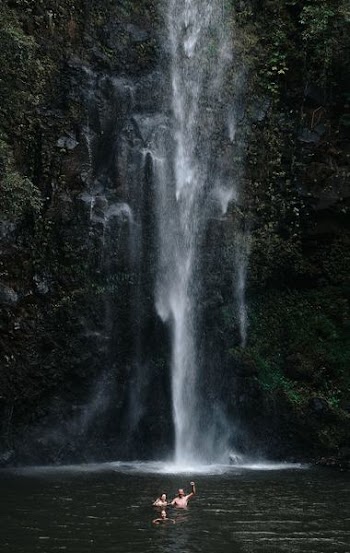 two persons near waterfalls