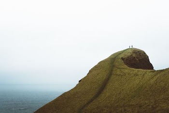 two persons on hilltop during daytime