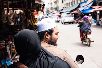 two persons riding motorcycle