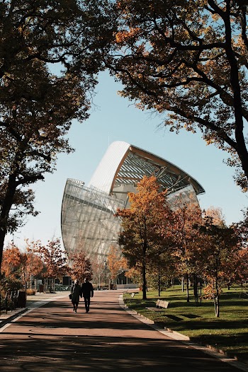 Two Persons Walking Towards Building