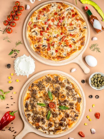 Two pizzas on the table top view Free Photo