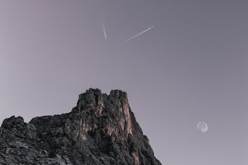 Two Planes Flying over Rock Formation at Dawn