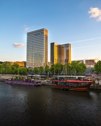 Two Purple and Maroon Boats Near Buildings