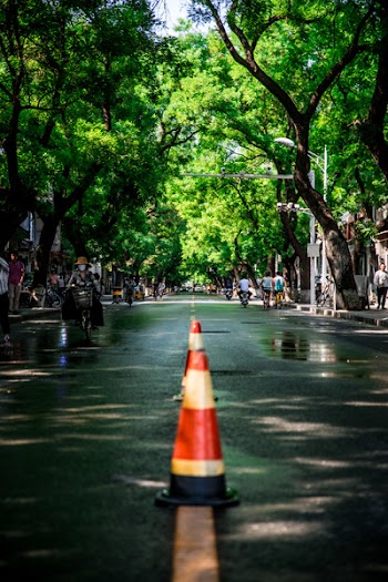 Two Red-and-white Traffic Cones in Middle on Road