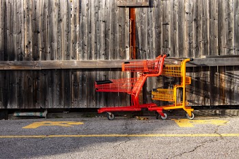 Two Red and Yellow Shopping Carts Beside Wall