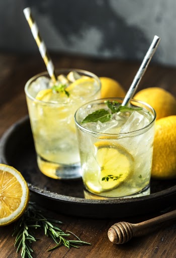 Two Shot Glasses Filled With Lemon Juice