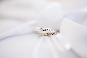 Two Silver-colored Wedding Rings on White Textile