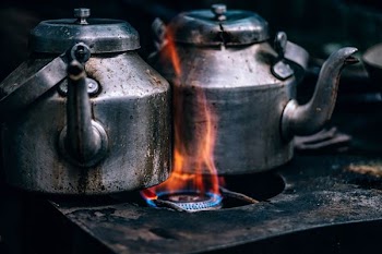 two silver kettle burning