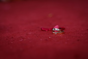 Two Silver Rings on Red Surface