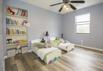 Two Single Beds Beside Books Shelf Inside Room