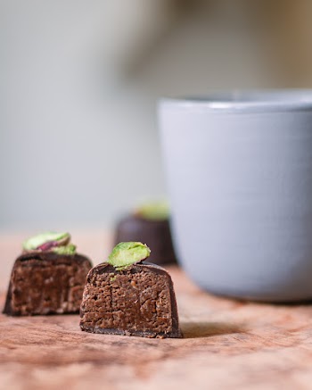 Two Sliced Chocolates Near Mug