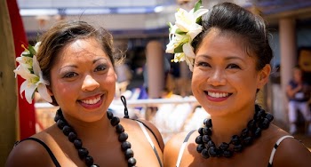 Two Smiling Woman Wearing White Floral Headdress