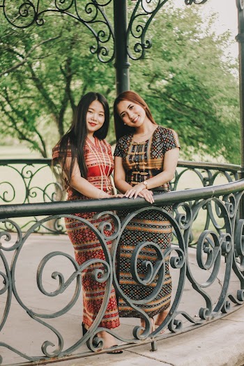 Two Smiling Women Standing Next to Each Other