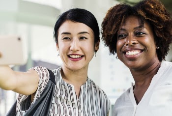 Two Smiling Women Taking A Photo