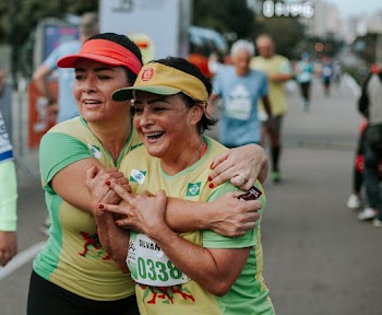 Two Smiling Women Wearing Yellow-and-green Shirts