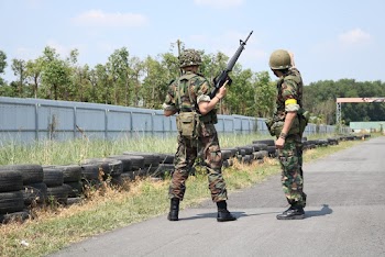 Two Soldiers Standing On Road