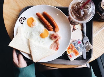 two sunny side up eggs on white plate