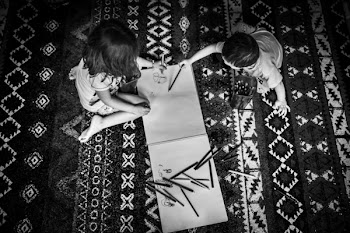 Two Toddler's Writing on a Sketch Pad
